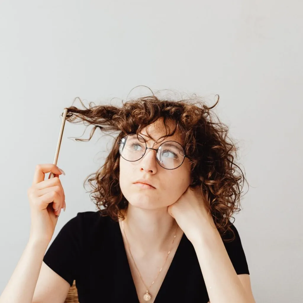 Curly woman thinking